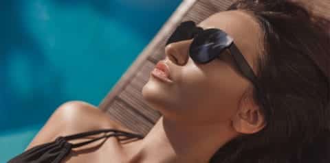 woman sunbathing by pool